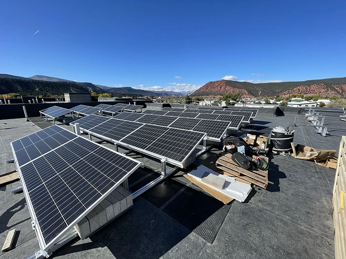 Solar panels installed on a log cabin roof